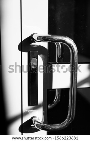 door handle with lock on a sheet metal door with windows