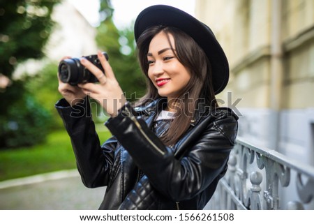 Young pretty girl making pictures with her camera