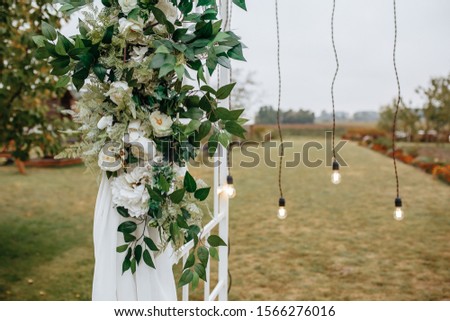 Beautiful Wedding Arch Of Flowers On A Background Green Field