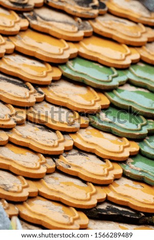 Colorful ceramic roof tiles at Bangkok Grand Palace & Wat Phra Kaew (Emerald Buddha Temple) Garden.