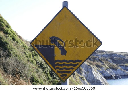 Road sign on cliff edge