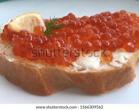Sandwiches with red caviar and butter on a white background