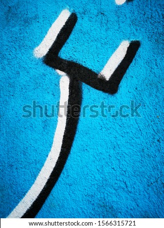 black and white 2 two pronged fork on vivid blue background geometric shapes and pattern