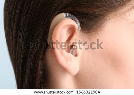 Young woman with hearing aid, closeup