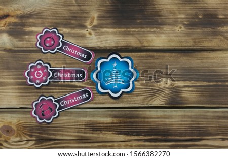 Color sticker with Christmas illustration on wooden background