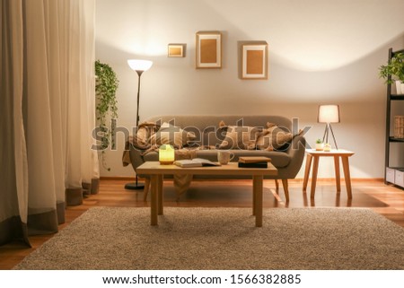 Stylish interior of living room at night Royalty-Free Stock Photo #1566382885