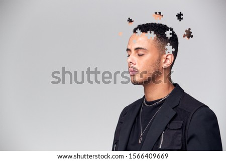Mental Health Concept Of Young Man With Jigsaw Shaped Pieces Missing From Mind Royalty-Free Stock Photo #1566409669