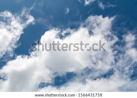 Clear blue sky. Picture of blue sky filled with clouds. White and blue background. Navy tone background. Blue sky background with clouds. Sky Clouds