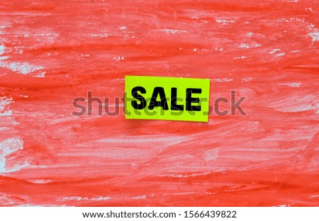Text Sale on a small sheet and a red background. Sale time in stores - concept as a background