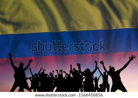 Peoples silhouette on flag and sky background, day of Colombia, independence holiday 