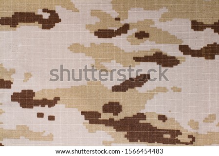 A texture of a pixelated camouflage fabric in a close up view