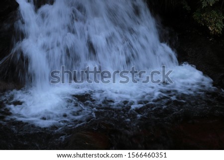 Autumn waterfall and river landscape.