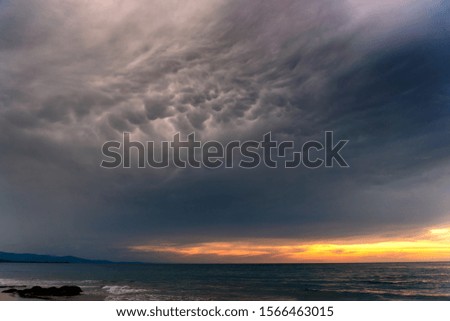 Dark and dramatic sunset clouds over sea. Nature composition. Soft landscape theme.