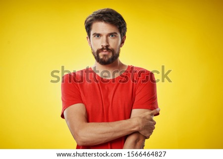 Red shirt handsome man yellow background confident look