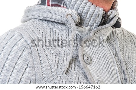 Young man in winter clothes getting cold.  picture of a male fashion model wearing wool sweater.  studio picture of a young man dressed for winter.
