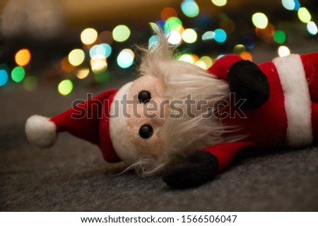 christmas santa claus toy on garland background