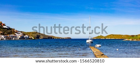 Greece, Kea island, Vourkari. White yacht on clear blue sky and calm sea background, panoramic view, banner