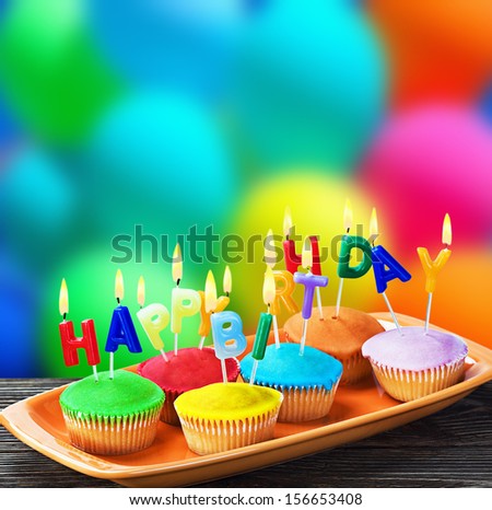 colorful happy birthday cupcakes with candles  