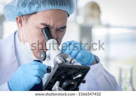 Asian man scientist researching  and learning in a laboratory.