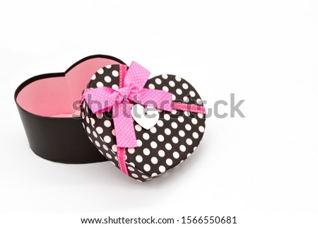  heart shaped gift box pink bow on white background