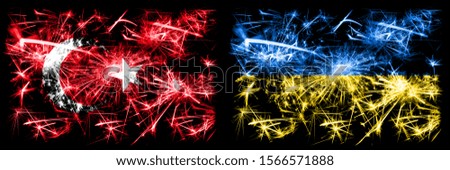 Turkey, Turkish vs Ukraine, Ukrainian New Year celebration sparkling fireworks flags concept background. Combination of two abstract states flags.
