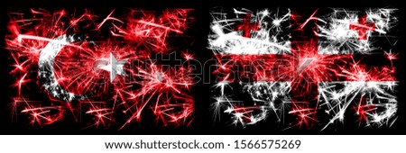 Turkey, Turkish vs Georgia, Georgian New Year celebration sparkling fireworks flags concept background. Combination of two abstract states flags.
