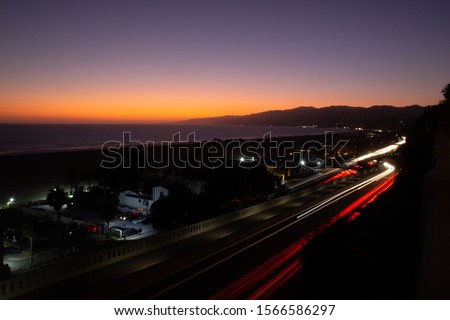Santa Monica sunset. This long exposure photo was taken with my Canon 60d, from the hand rail across the road from my hotel. I waited patiently for the car lights to be just right.  Royalty-Free Stock Photo #1566586297