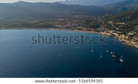 Aerial Drone View of Plage d'Algajola with Some Boats in the Bay Corsica