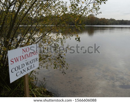 No swimming - Cold water can kill - warning sign by a lake