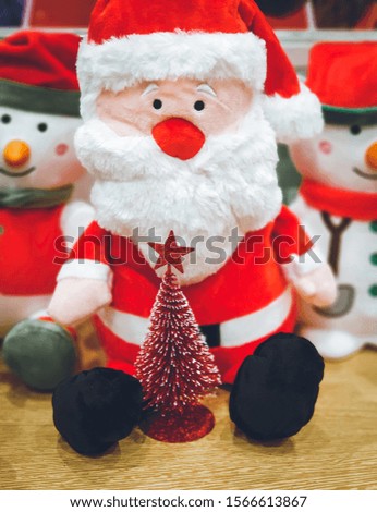 Doll cute santa claus and red christmas tree decorated celebrate the Christmas festival. xmas background.