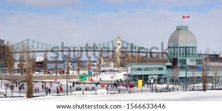 Old Port of Montreal ice skating rink with Jacques Cartier Bridge on the background in winter, Canada