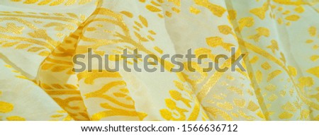 Texture, pattern, collection, silk fabric, women's scarf, golden pastel on a beige background, Printed golden paisley photograph