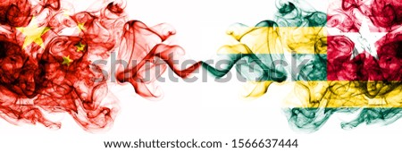 China, Chinese vs Togo, Togolese smoky mystic states flags placed side by side. Concept and idea thick colored silky abstract smoke flags