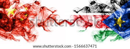 China, Chinese vs South Sudan smoky mystic states flags placed side by side. Concept and idea thick colored silky abstract smoke flags