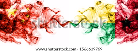 China, Chinese vs Guinea Bissau smoky mystic states flags placed side by side. Concept and idea thick colored silky abstract smoke flags