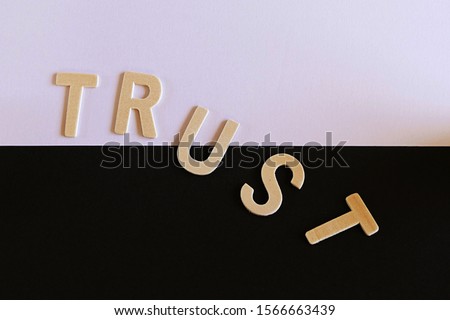 Trust word on the white and black paper. with not arrange properly. the trust seem to be falled and become lack of trust