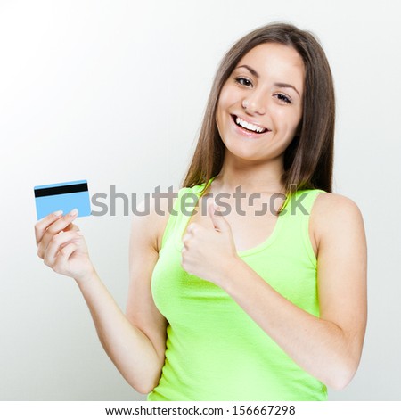 young smiling woman holding credit card