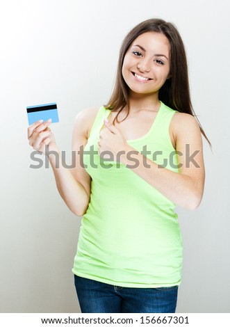 young smiling woman holding credit card