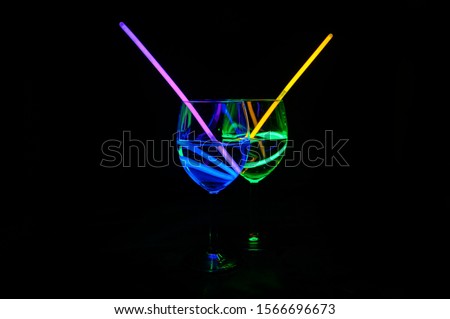 Colorful alcoholic transparent beverages with dark background for party celebration, new year, bar and christmas with straw decor