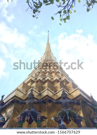 Golden stupa and the Giants (Yak) at the Temple of the Emerald Buddha (Wat Phra Kaew or Wat Phra Si Rattana Satsadaram), Bangkok, Thailand, Southeast Asia. The picture was taken in January 2018.
