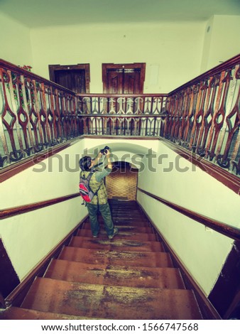 Hobby photographer takes photo of interior house built in 19th sentury.  Wooden staircase in middle of burgher house.
