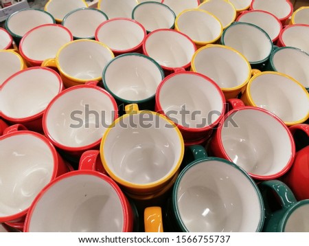 many multi-colored large cups with an eye