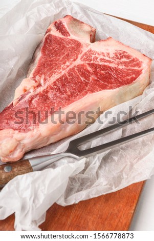 a piece of fresh farm meat t-bon non-GMO wrapped in eco-friendly wrapping paper