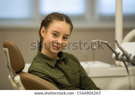 Portrait of a cute girl in the dental office. Health care and stomatology concept.