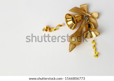 Christmas mood concept. Layout composition, traditional festive attributes, golden bell and ribbon decorations. Winter holidays season. Background, copy space, close up, top view, flat lay.