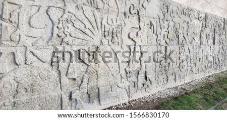 Wall with ancient carvings in Mexico