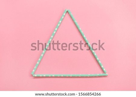 triangular frame with Colorful Paper coctail tubes on the pink background. Eco friendly. Zero Waste