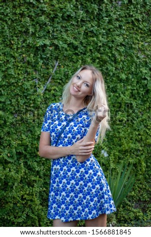 Girl with blond hair on green background