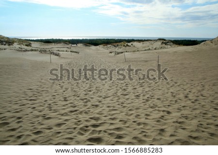 A picture from the Curonian Spit (Kursiu Nerija) National Park in Lithuania. The big sand dunes by the shore during the nice sunny day. 