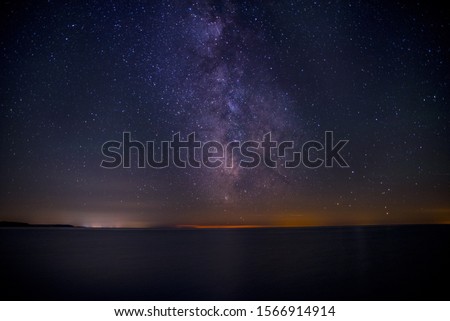 A beautiful shot of the dark purple sky filled with stars at the night